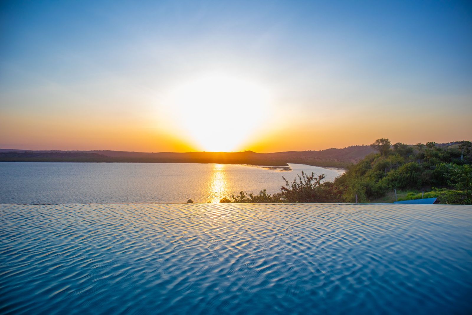 Sunset over the infinity pool, looking across Kilifi Creek